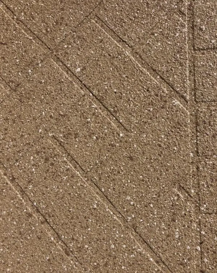 Close-up of a textured aggregate surface with saw-cut detail